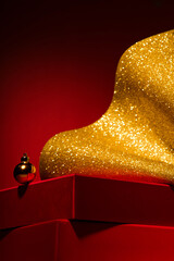 Empty Red podium with gift boxes, gold Christmas decor Red background.