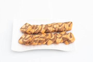 Square shaped Chocolate Chip Cookies Served In White Tray. Isolated On White Background With Copy Space For Custom Text. Side Angle View And Selective Focus