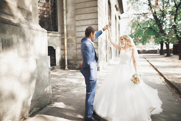 Naklejka premium Beautiful caucasian wedding couple just married and dancing their first dance