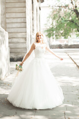 Beautiful bride spinning with perfect dress in the park