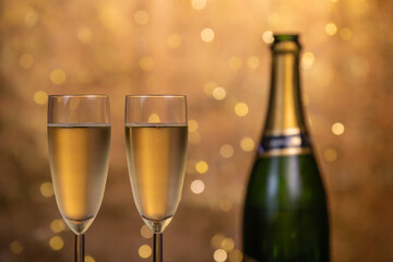 Champagne glasses over holiday bokeh blinking background, glasses with sparkling wine, celebration, party