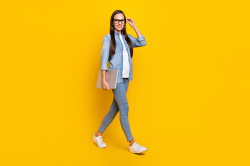 Fototapeta na wymiar Full size profile side photo of young pretty woman go walk eyewear confident smart agent isolated over yellow color background