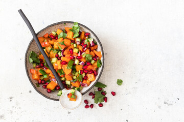 Persimmon Salsa. Healthy vegetarian bowl salad with Persimmon, pomegranate, cucumber, onion and cilantro.