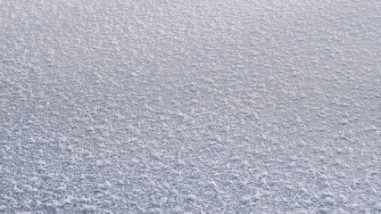 Texture of ice of frozen lake in sunlight