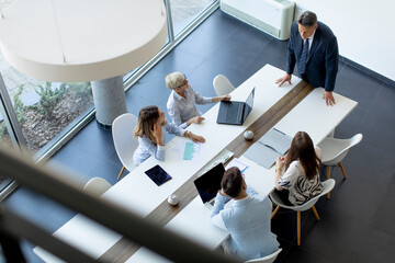 Aerial view at group of business people working together and preparing new project on a meeting in...