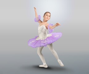 Naklejka premium Tips on toes. Young graceful ballerina dancing alone on background.