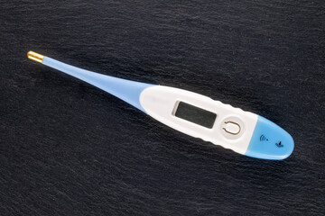 One thermometer on a slate stone, close-up, top view.