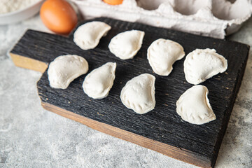 vareniki raw dough stuffed dumplings ready to eat meal snack on the table copy space food background