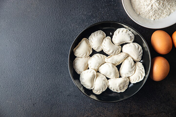 vareniki raw dough stuffed dumplings ready to eat meal snack on the table copy space food background