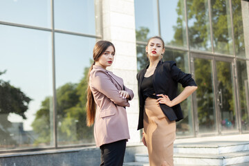 Two young beautiful business women outdoors