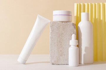 Face and body skin care products in a glass bottle with a pipette on the podium. Cosmetics for women with natural ingredients. Copy space, layout