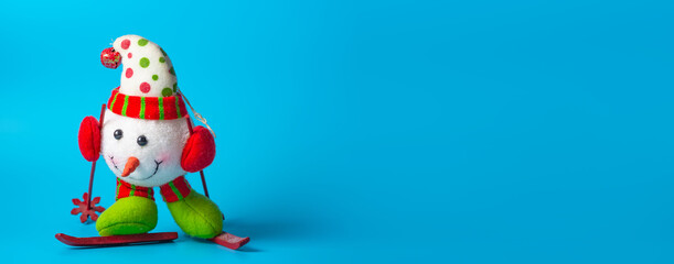 New Year's snowman on a blue background. Christmas or New Year theme. Banner. Place for your text.
