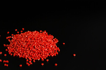 Many red granules of polypropylene, polyamide. Background. Plastic and polymer industry, industry. Microplastic products.
