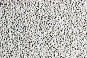 Many white and gray granules of polypropylene, polyamide. Background. Plastic and polymer industry, industry. Microplastic products.