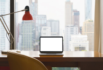 laptop white screen display on workspace see through city blur b - 469353823
