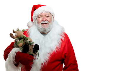 Happy Santa Claus in a red coat, gloves and a hat, holding a toy in hands, pointing his finger, white background.