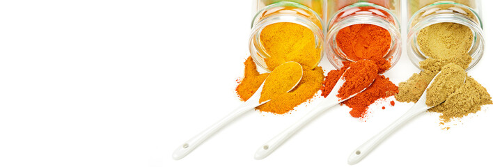 Chili, curry and turmeric powder isolated on white . Wide photo. Free space for text.