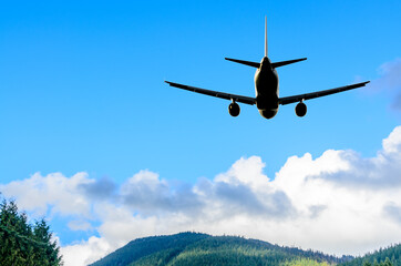 Fototapeta na wymiar flight of the airplane (jet) over beautiful blue sky with white clouds