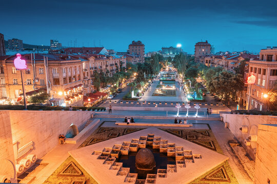 24 May 2021, Yerevan, Armenia: Night view from the Cascade monument to the evening urban landscape of Yerevan with tourists resting on a stairs
