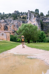 Fototapeta na wymiar Panoramic view of unrecognizable man walking isolated in nature with backpack. Vertical view of man traveling alone in the Lobos river canyon in Soria. People and travel destinations in Spain.