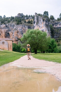 Panoramic view of unrecognizable man walking isolated in nature with backpack. Vertical view of man traveling alone in the Lobos river canyon in Soria. People and travel destinations in Spain.