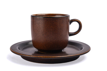 brown clay cup on a saucer on a white background close up