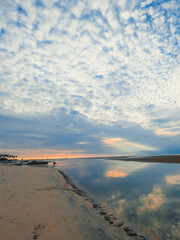 orange sunset on the horizon with blue sky near beach