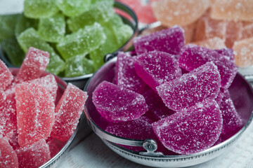 Dessert marmalade in the form of lemon and orange slices. The sweetness of jelly candy.