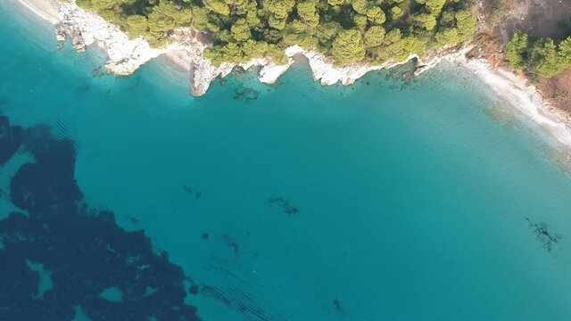 Aerial panoramic view over Milia beach in Skopelos island, against a cloudy sky in Sporades, Greece