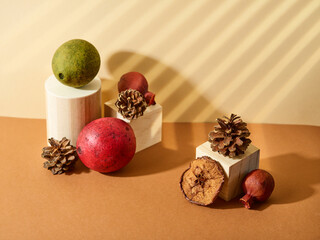 Original collage on a beige background - geometric shapes, fruits and cones. Concept - interior...