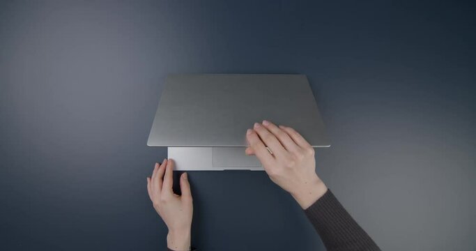 Office table. Hands of a girl working on a laptop. Flat lay. Copy space