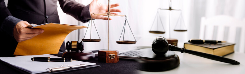 justice and law concept.Male judge in a courtroom on wooden table and Counselor or Male lawyer...