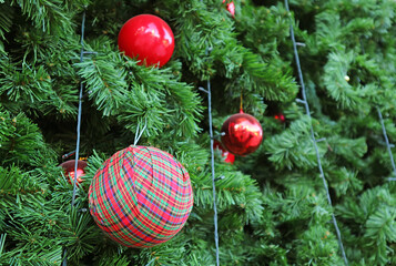 Beautiful red and checkers balls ornaments on the Christmas tree