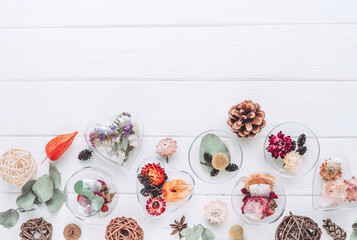 Obraz na płótnie Canvas DIY ornaments filled with dried flowers on white background