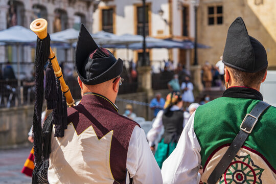 Two men dressed in Asturian costume playing the drum and bagpipes in a square in Oviedo, Uvieu, in Asturias. 