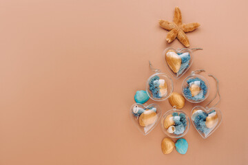 Beach DIY ornaments with seashell and moss on beige background