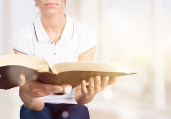 Human hand hold and reading the open bible,