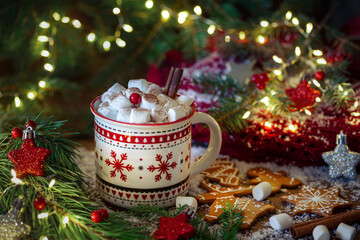A cup of hot chocolate with marshmallows and gingerbread on a festive background. Christmas mug...