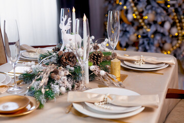 Candle, decorated with cinnamon sticks on Christmas table