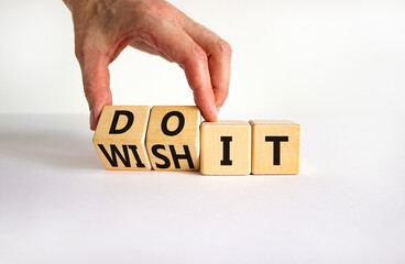 Wish and do it symbol. Businessman turns cubes and changes words 'wish it' to 'do it'. Beautiful white table, white background. Business and wish and do it concept. Copy space.