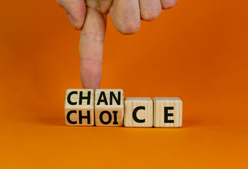 Choice and chance symbol. Businessman turns wooden cubes and changes the word 'choice' to 'chance'. Beautiful orange table, orange background, copy space. Business and choice and chance concept.