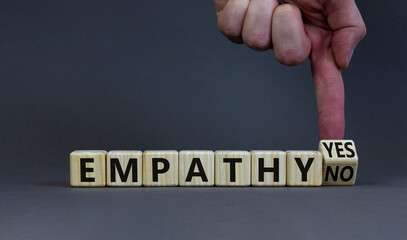 Empathy yes or no symbol. Psychologist turns wooden cubes and changes words empathy no to empathy...