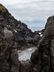 Natural pools delimited by volcanic rocks in the bathing area of Boqueirão. Breathtaking textures and green vegetation contrasting with the black color of the rocks.
Flores Island.