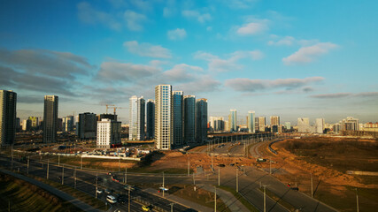 Construction site. Construction of modern multi-storey buildings. Against the background of the blue sky. Aerial photography.