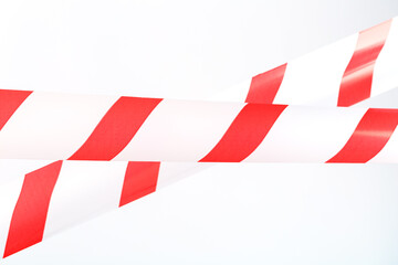 The tape is red and white for fencing danger on a white background.