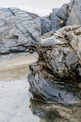 Wet rokcs and sand on low tide.