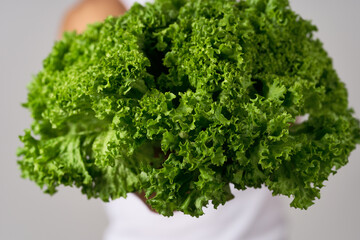 Obraz premium cheerful man in a white t-shirt lettuce leaves healthy food