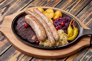 Traditional german fried meat with boiled potatoes, red cabbage and vegetables