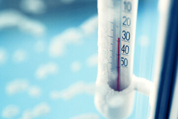 Classic mercury thermometer for measuring ambient temperature, hanging outside the window, with readings minus 30 degrees Celsius