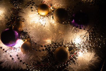 Chistmas lights with white tinsel and warm tones. For graphic uses around the festive season. 